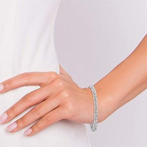 Close up view of a woman's hand wearing a Miabella Italian 925 Sterling Silver Byzantine Bracelet